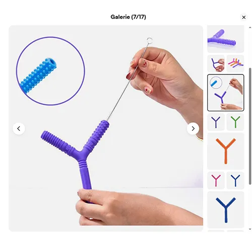 Jucărie de dentiție din plastic moale violet în formă de litera Y, cu diferite texturi. Produs vândut online, în special prin intermediul eBay (identificator unic: 197497295169).