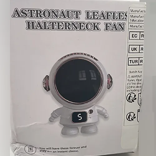 Ventilator electric negru în formă de astronaut de aproximativ 10 cm, cu cablu USB în cutie de carton.
